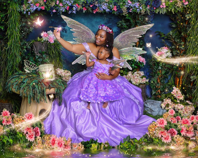 Mother and daughter in matching purple fairy dresses with crystalline wings
